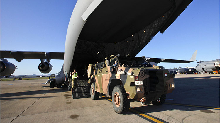 An Australian Army Bushmaster Infantry Mobility Vehicle is loaded onto a Royal Australian Air Force (RAAF) C-17 Globemaster at RAAF Base Amberley for transport to RAAF Learmonth during Exercise Northern Shield 2015.