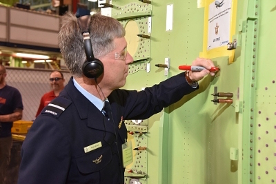 AIRCDRE Brown signs a panel to be fitted to the first RAAF P-8A.