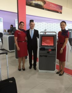 Virgin Australia chief executive John Borghetti at the self-service checkin kiosk with staff. (Jordan Chong)