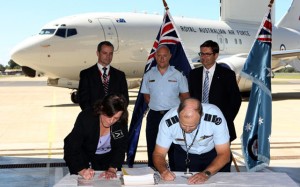 Maureen Dougherty and Air Vice-Marshal Chris Deeble sign the contract for Wedgetail TLS.