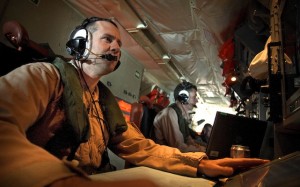 Warrant Officer Dave Dyer tracks a contact of interest from an AP-3C Orion's radar console. (Dept of Defence)