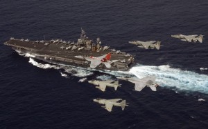 The Super Hornet - pictured here with Indian Sea Harriers and Jaguars and a classic Hornet over the USS 'Kitty Hawk' - is a contender for India's delayed fighter program. (US Navy)