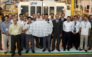 Embraer employees hold the first part produced for the Legacy 500, with Embraer COO Artur Coutinho and EVP, executive jets, Luís Carlos Affonso. (Embraer)