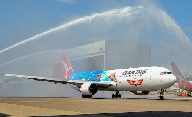 VH-OGG gets an ARFF water canon salute as it taxis out to depart on its 'Planes' premiere flight. (Mark Sherborne)