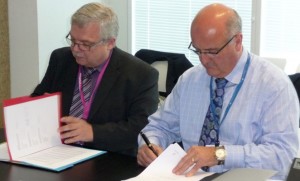 Russell Hulstrom, General Manager Airways Global Services (right) and Heinz-Michael Kraft, CEO of GroupEAD (left) sign the joint venture agreement in Madrid. (Airways NZ)