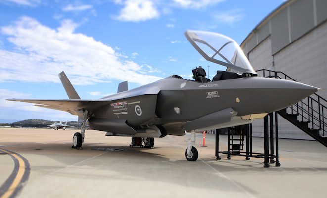 Lockheed Martin's F-35 mockup wearing RAAF roundels and with a RAAF Hornet in the background. (Paul Sadler)