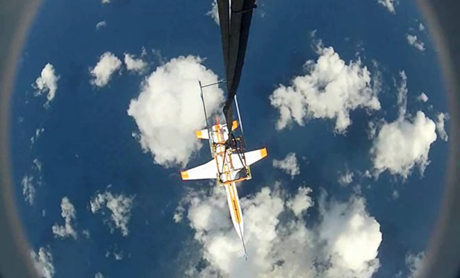 A captured video frame image of the Airbus spaceplane demonstrator suspended below the AS350 shortly before being released. (Airbus)