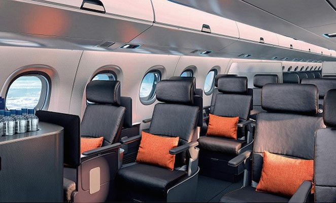 The E2 cabin mock-up showing the staggered first class seating arrangement and redesigned overhead bins and panels. (Embraer)
