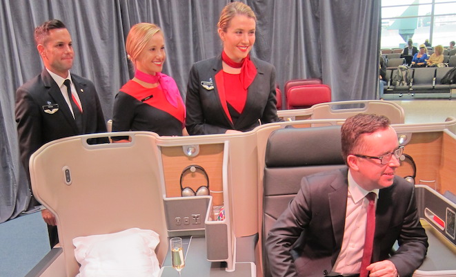 Qantas chief executive Alan Joyce models the new Qantas business class seat. (Jordan Chong)