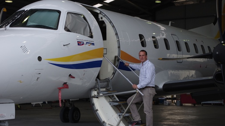 Air South director Mark Lindh with the airline's newly acquired Embraer Brasilia 120. (Air South)