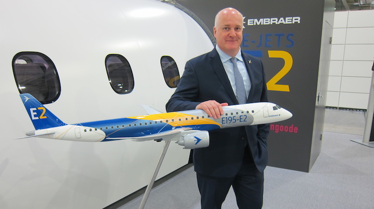Embraer vice president of Asia-Pacfic Mark Dunnachie   in front of the cabin mockup in Singapore on January 19. (Jordan Chong)