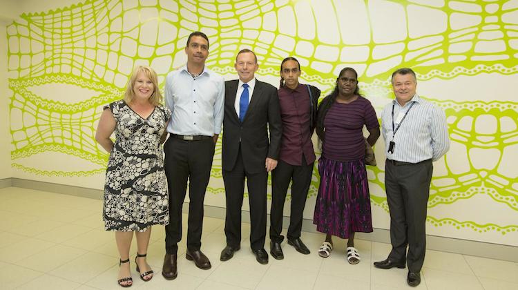 Prime Minister Tony Abbott at the airport opening in front of artist Aaron McTaggart's (second from left) artwork Crocodile that is featured in the new terminal. (Darwin Airport)