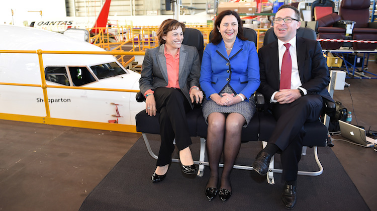 Queensland Deputy Premier Jackie Trad, Premier Annastacia Palaszczuk and Qantas chief executive Alan Joyce try Qantas's Boeing 737-800 economy seats at Brisbane. (Qantas)