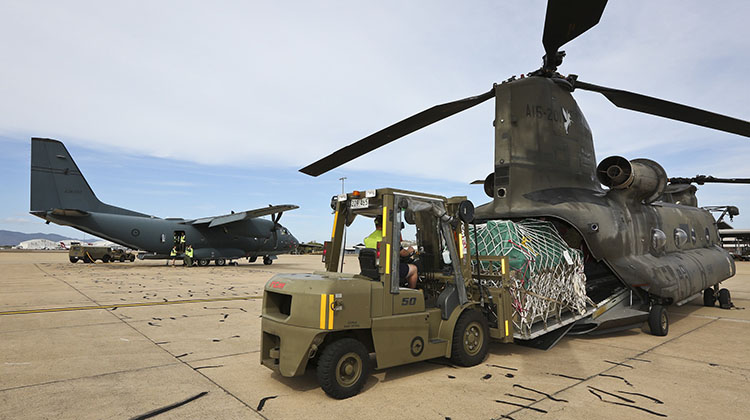Royal Australian Air Force and Australian Army personnel conduct load transfer trials between a C-27J Spartan battlefield airlifter aircraft and an Australian Army CH-47 Chinook helicopter at RAAF Base Townsville, Queensland, on 11 November 2015.