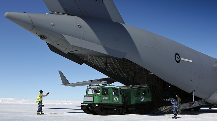 A Hägglunds snow vehicle is driven off a C-17A Globemaster at Wilkins Aerodrome.