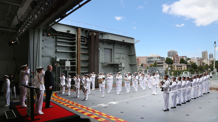 Governor General Sir Peter Cosgrove receives a Royal Salute from the band and Commissioning Guard during HMAS Adelaide's Commissioning ceremony.
