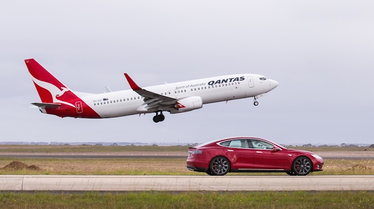 A Qantas Boeing 737-800 VH-XZI and a Tesla Model S electric car at Avalon Airport. (Qantas) 