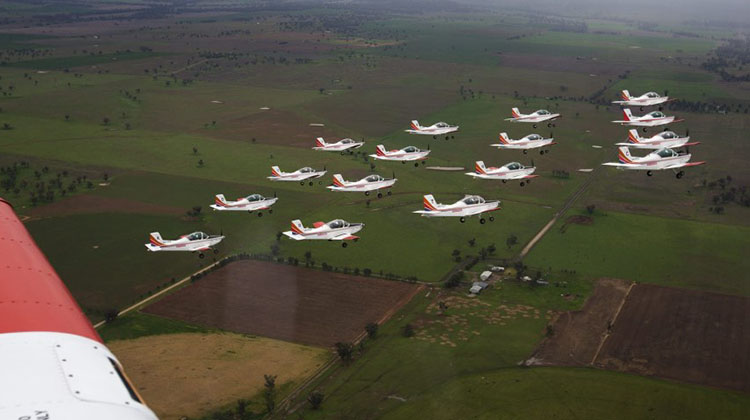 Sixteen Pacific Aerospace CT-4B Airtrainer aircraft from the Basic Flying Training School fly in formation over Tamworth.