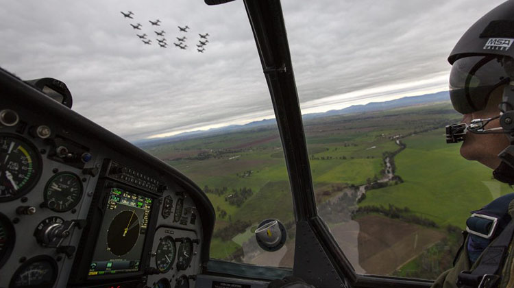 Lieutenant Commander Andrew Kidd, a Qualified Flying Instructor from the Basic Flying Training School, follows a formation of sixteen Pacific Aerospace CT-4B Airtrainer aircraft flying over Tamworth.