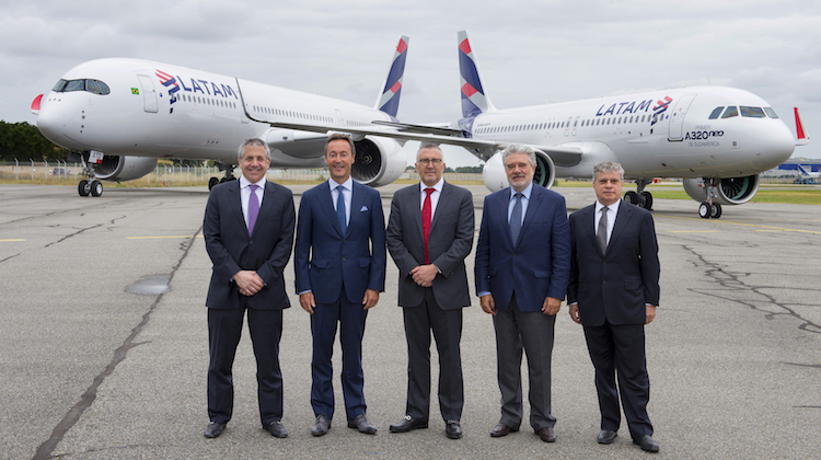 Airbus and LATAM executives pose in front of the airline's fourth A350 and first A320neo. (Airbus)