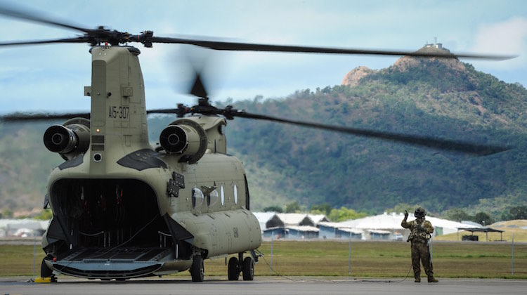 An Australian Army loadmaster performs pre-flight checks on an Army CH-47F Chinook helicopter on the flightline at RAAF Base Townsville in Queensland on 23 August 2016.