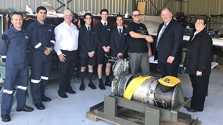 Toll Helicopters’ general manager Mark Delaney presents the PT6T engine to Aviation High School’s head of aviation Jack Clarke. (Toll Helicopters)