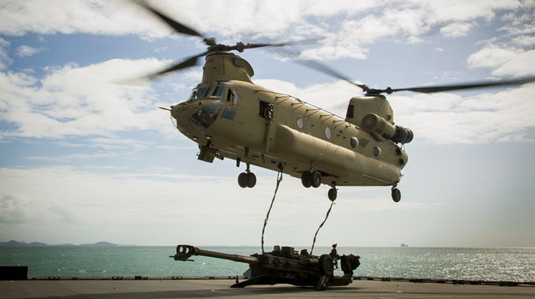 An Australian Army CH-47D Chinook helicopter from the 5th Aviation Regiment in Townsville prepares to lift a 155mm M198 Howitzer from the flight deck of HMAS Choules during an amphibious landing conducted on July 13 as part of Talisman Saber 2017. (Defence)
