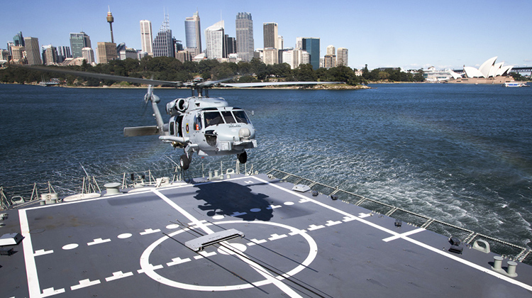An MH-60R Seahawk Helicopter from 816 Squadron lands on HMAS Hobart's flight deck during a flight deck trial alongside Fleet Base East, Garden Island, Sydney. (Defence)