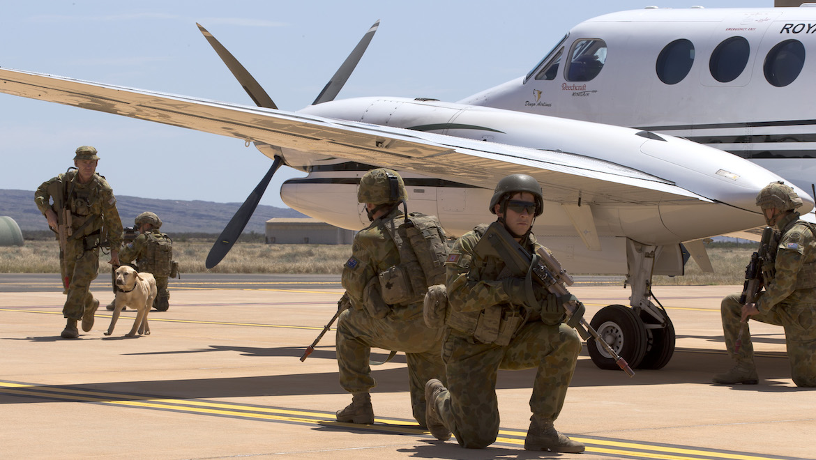 A Ready Combat Team conducts a security search of a 38SQN King Air at RAAF Base Learmonth during Exercise Northern Shield 2015. (Defence)