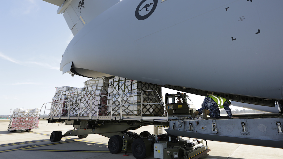 Royal Australian Air Force No. 23 Squadron Air Load Team member loads Australian humanitarian aid and disaster relief supplies bound for Indonesia onto a Royal Australian Air Force No. 36 Squadron C-17A Globemaster aircraft at RAAF Base Amberley, Queensland. (Defence)