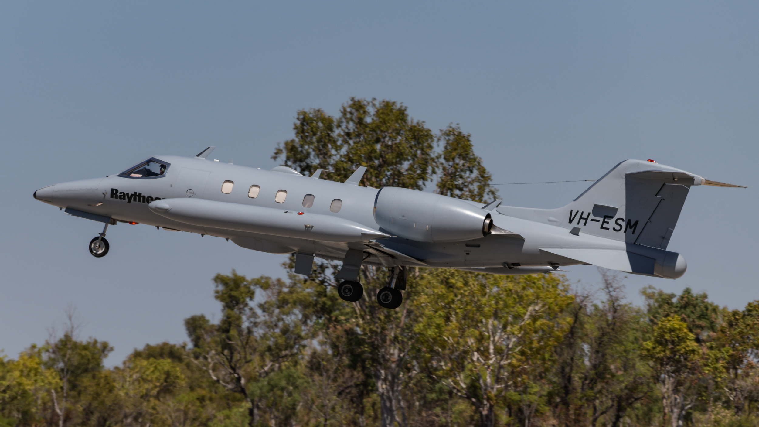 Raytheon Australia-operated Learjet 35A VH-ESM, which is used for electronic warfare training, departs Tindal. (Mark Jessop)