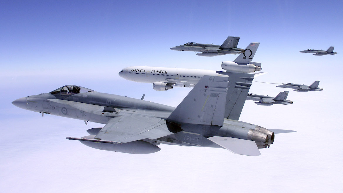 A swarm of F/A-18 Hornets from No. 3 Squadron fly along side the Omega air-to-air refuelling tanker en-route to Alaska from Australia for Exercise Red Flag. (Defence)