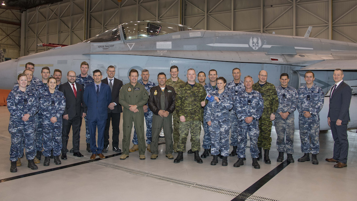Members of the Royal Australian Air Force (RAAF), the Royal Canadian Air Force and representatives of the Interim Fighter Capability Project stand in front of the newly arrived RAAF F/A-18. (Cold Lake Imagery/Canada)