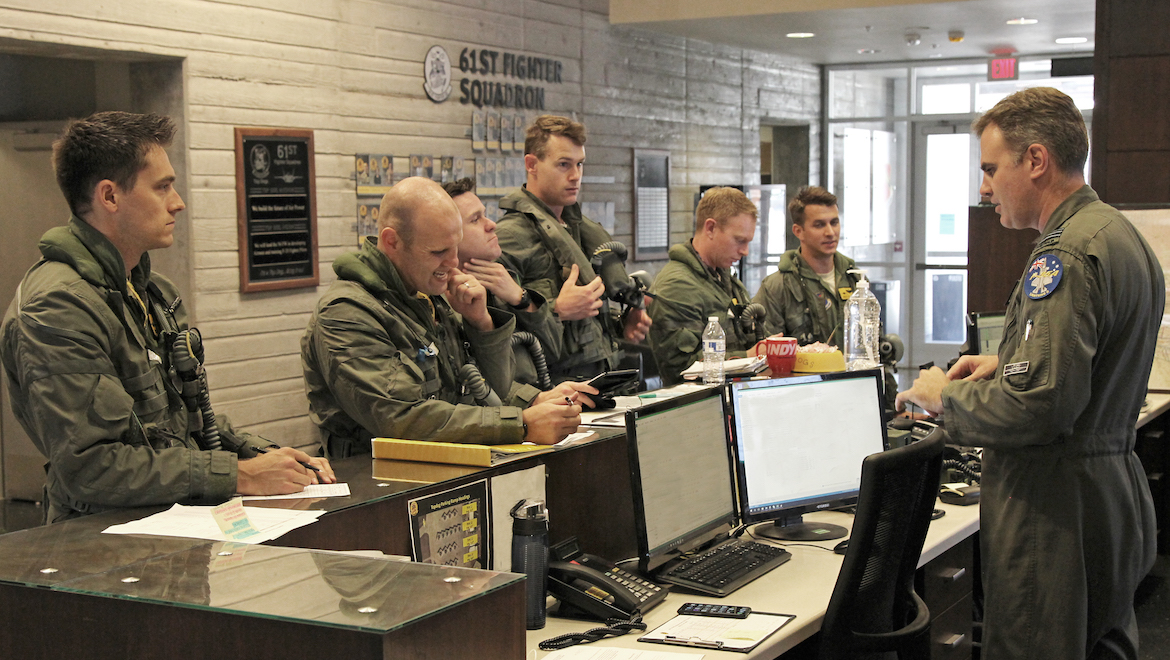 WGCDR Darren Clare briefs RAAF and USAF pilots before a mission. (Andrew Mclaughlin)