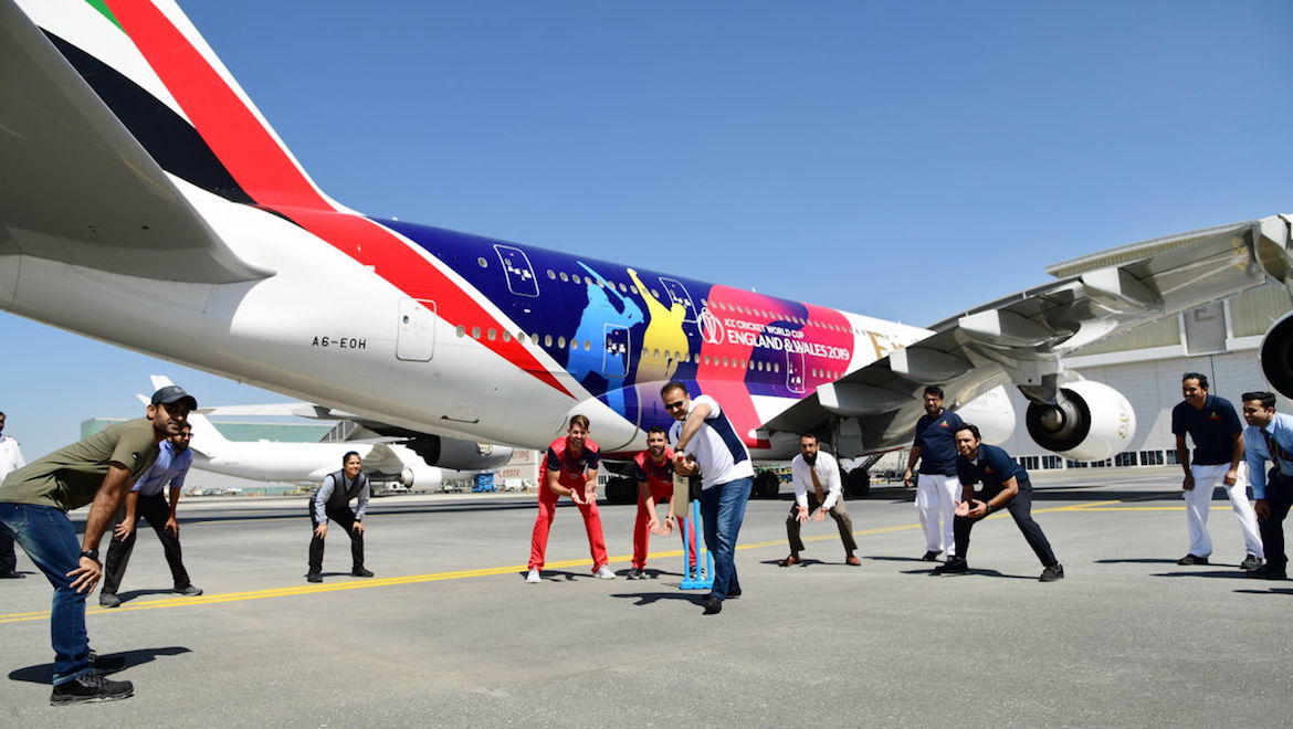 Emirates engineering staff play a game of cricket on the tarmac with retired cricketer Virender Sehwag. (Emirates)