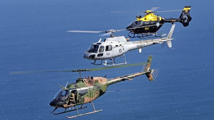 An Australian Army OH-58A Kiowa leads a Royal Australian Navy AS-350BA Squirrel and its replacement a Eurocopter EC-135 over the skies of Nowra, NSW (Defence)