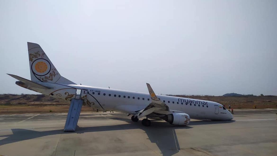 An image of Myanmar National Airlines Embraer E190 XY-AGQ after it landed at Mandalay without its nose gear extended. (Myanmar National Airlines/Facebook)