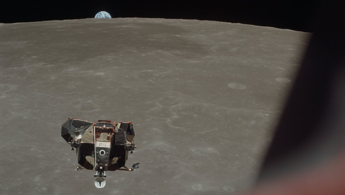 A look at the Apollo 11 Lunar Module from the Command and Service Modules in lunar orbit, with the earth rising above the lunar horizon. (NASA/Flickr)