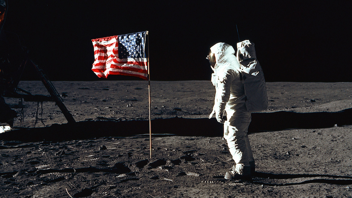 Astronaut Buzz Aldrin standing on the moon besides the United States flag. (NASA/Flickr)