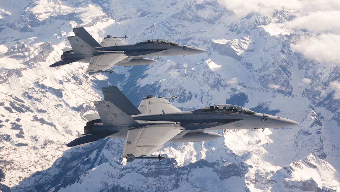 F/A-18E/F Super Hornets in flight over mountains, snow. In route to India Aero Show. (Boeing)