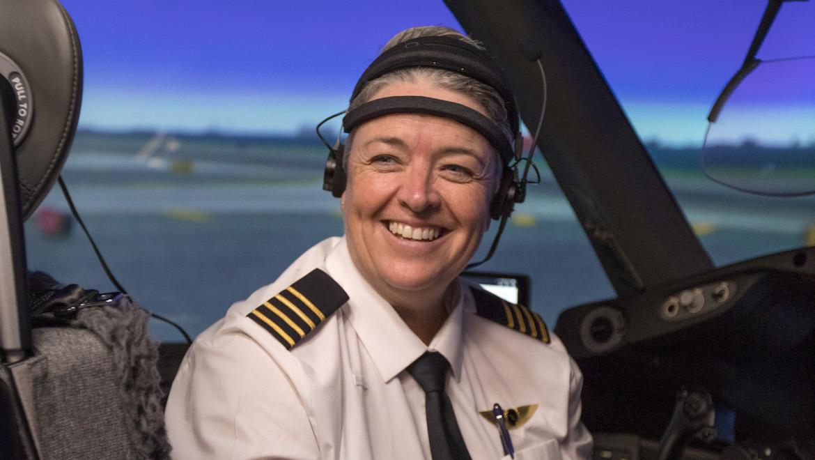 Captain Lisa Norman in the flight simulator wearing the electroencephalogram brain monitoring equipment.