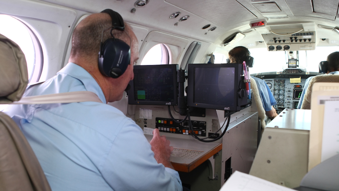 Flight inspector Tony Hine monitors the results during an approach on the Airservices King Air. (Paul Sadler)